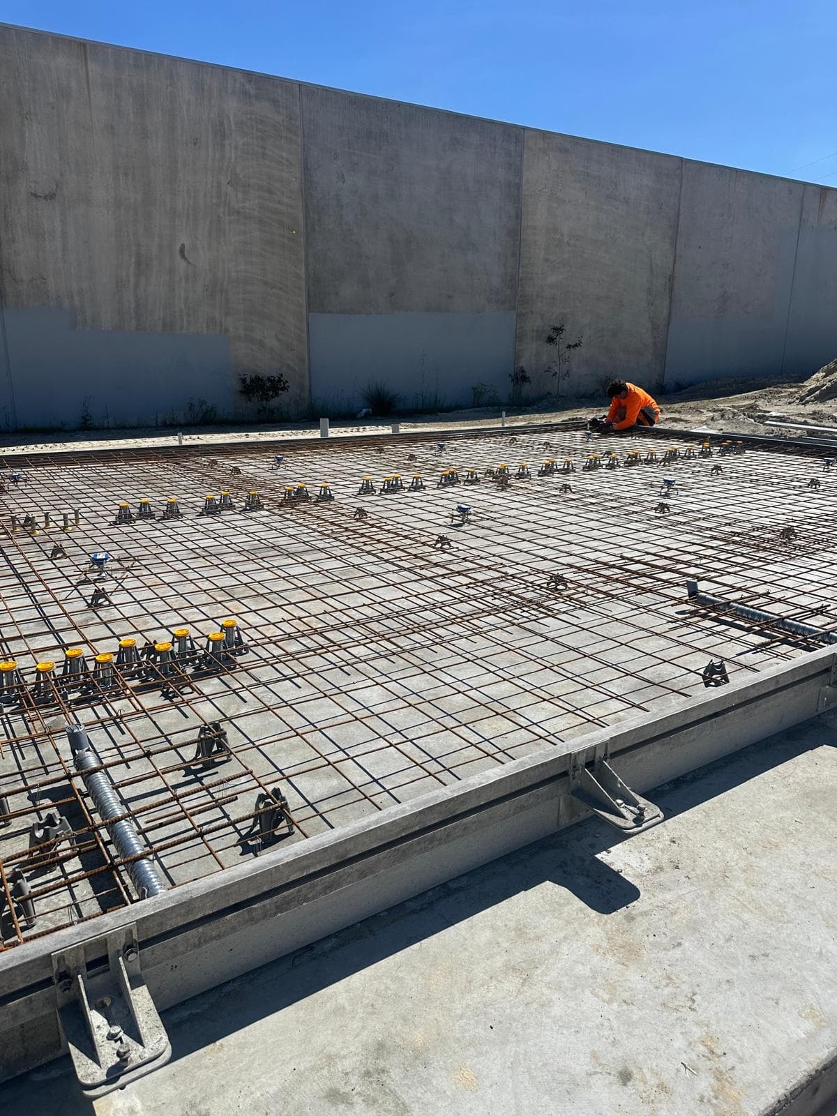 Rebar grid with tilt-up wall panel behind