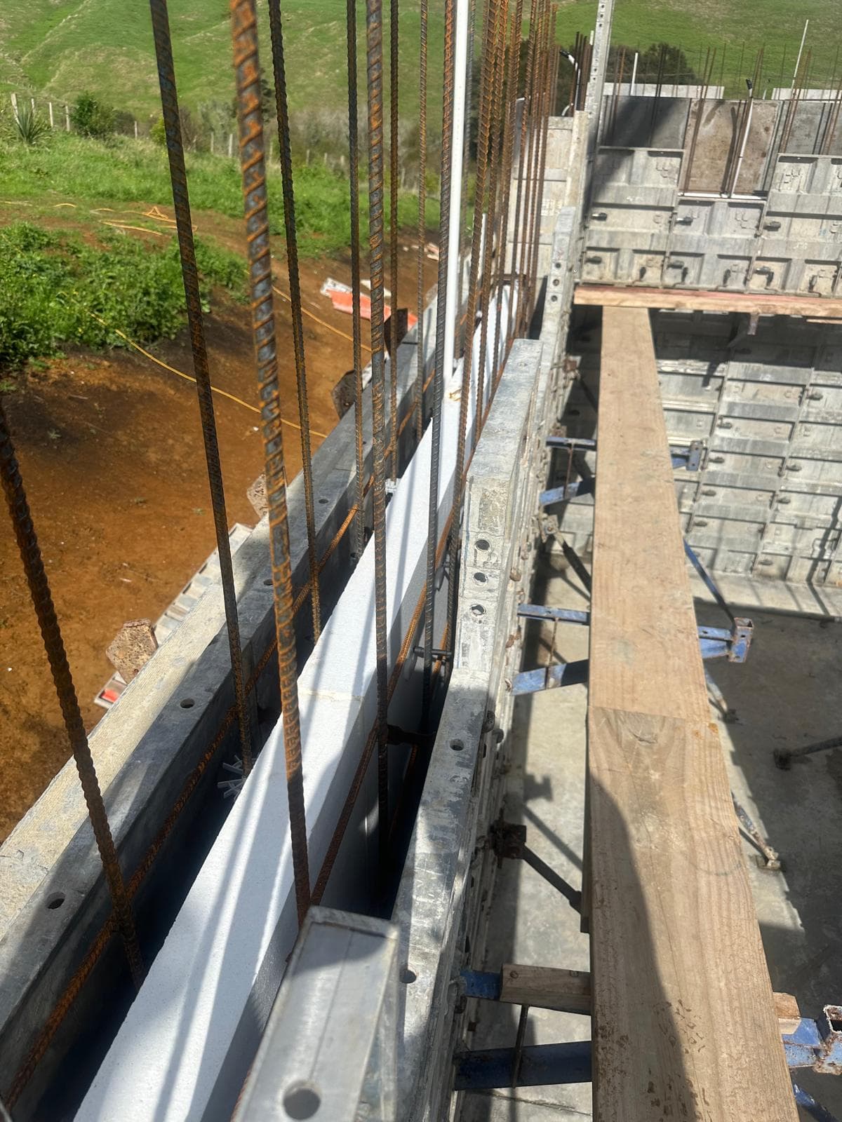Close-up of ThermaCast wall — rebar, insulation, and formwork